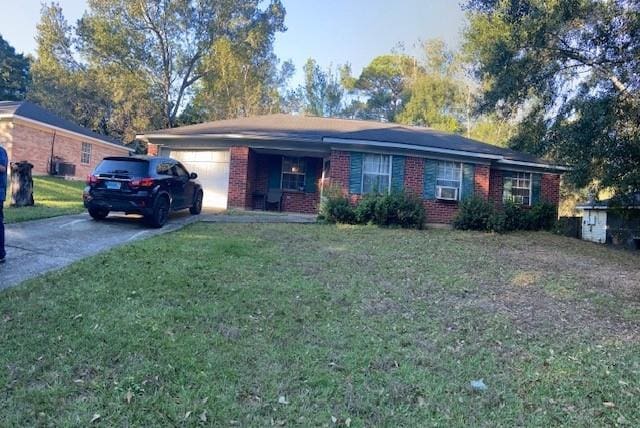 ranch-style home with a garage and a front lawn