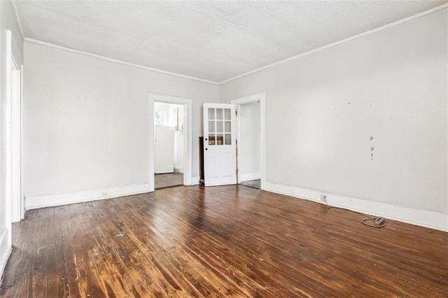 spare room featuring crown molding, dark hardwood / wood-style floors, and a textured ceiling