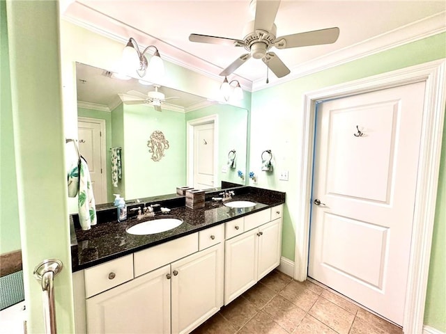 bathroom with double vanity, crown molding, ceiling fan, and a sink