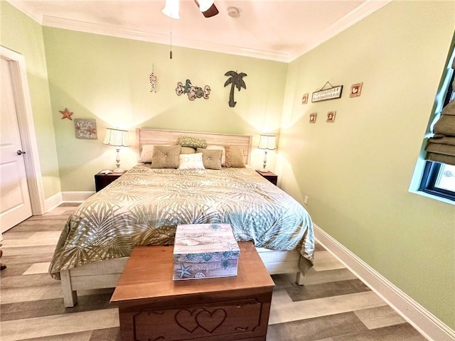 bedroom with baseboards, ornamental molding, ceiling fan, and wood finished floors