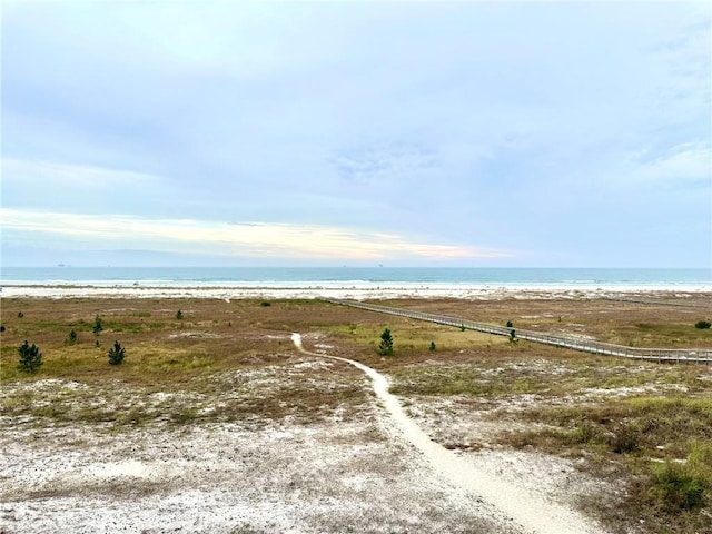 exterior space featuring a beach view and a water view