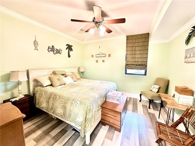 bedroom featuring baseboards, light wood finished floors, a ceiling fan, and crown molding