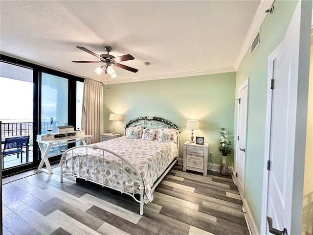 bedroom featuring hardwood / wood-style floors, expansive windows, ceiling fan, and crown molding