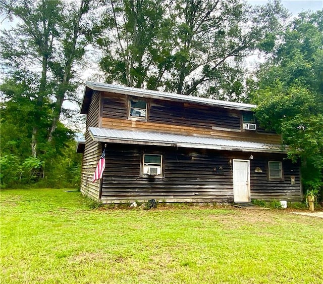 back of property with a lawn and cooling unit