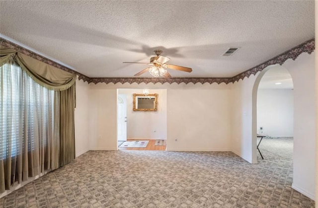 empty room featuring carpet flooring, a textured ceiling, and ceiling fan