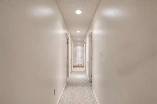 hallway featuring light carpet