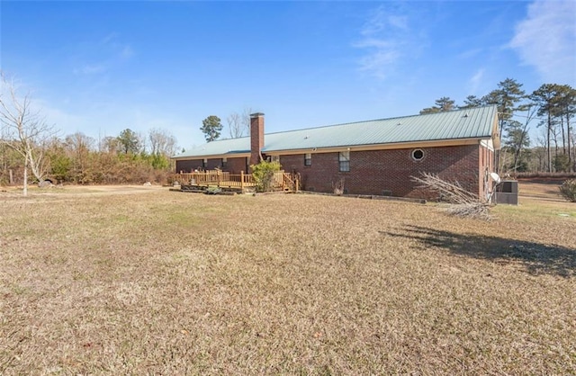 rear view of property featuring a lawn