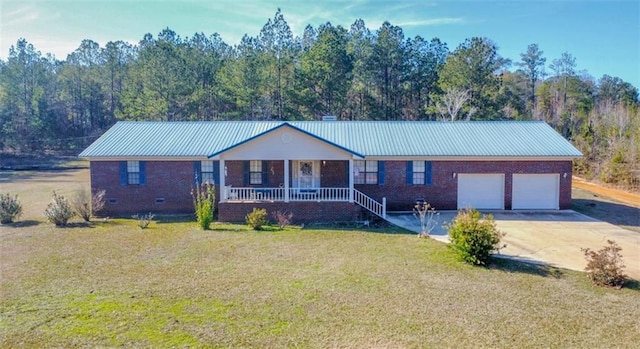 ranch-style home with covered porch, a front yard, and a garage