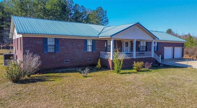 ranch-style house with covered porch, a front yard, and a garage