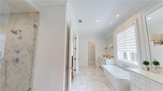 140E Mcgregor Ave S, Mobile, AL 36608 - bathroom featuring a marble finish shower, a freestanding tub, marble finish floors, vanity, and recessed lighting