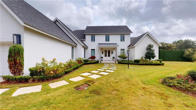140E Mcgregor Ave S, Mobile, AL 36608 - view of front of home featuring a front yard, brick siding, and roof with shingles
