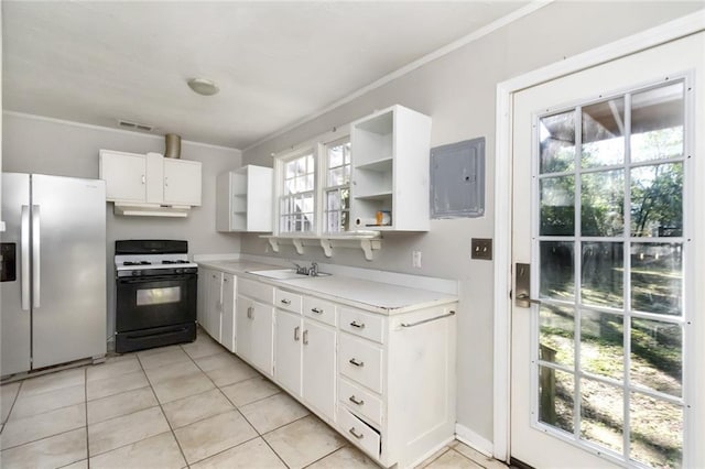 kitchen featuring a sink, range with gas stovetop, electric panel, open shelves, and stainless steel fridge