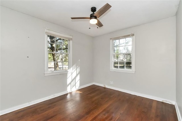 unfurnished room with dark wood finished floors, baseboards, and ceiling fan