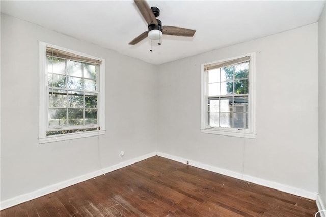 empty room with ceiling fan, baseboards, and dark wood-style flooring