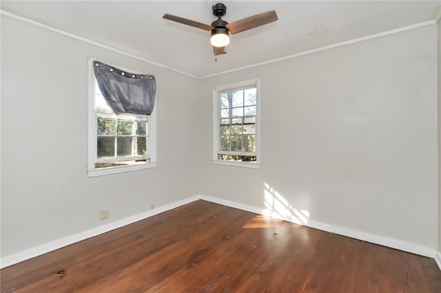 unfurnished room with plenty of natural light, baseboards, wood finished floors, and ornamental molding