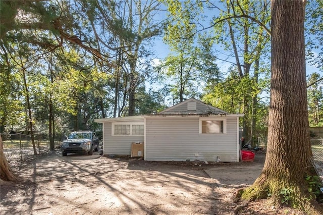 exterior space featuring driveway and fence