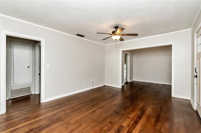 unfurnished room with ornamental molding, visible vents, dark wood finished floors, and baseboards