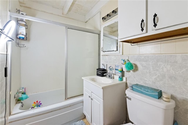 full bathroom featuring shower / bath combination with glass door, vanity, backsplash, tile walls, and toilet