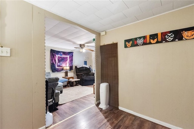 hallway with hardwood / wood-style flooring