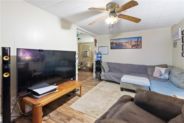 living room with ceiling fan, ornamental molding, light hardwood / wood-style floors, and a wall unit AC