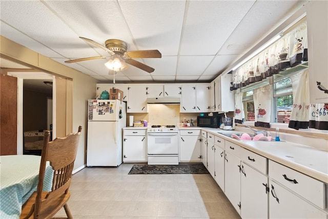 kitchen with ceiling fan, sink, white appliances, and white cabinetry