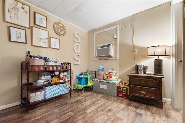 living area featuring hardwood / wood-style floors and a wall mounted AC