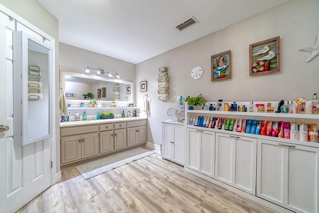 4698 Clarendon Dr, Mobile, AL 36619 - full bathroom with a sink, double vanity, wood finished floors, and visible vents