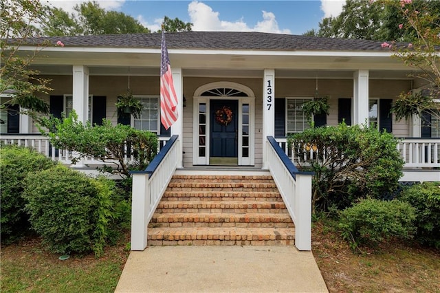 view of exterior entry with a porch