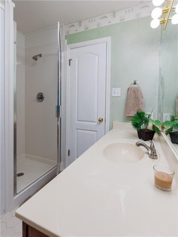 bathroom featuring vanity, a textured ceiling, and walk in shower