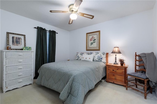 bedroom featuring ceiling fan and carpet