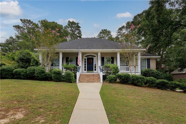 view of front of house with a front yard and covered porch