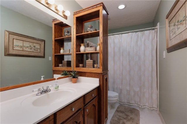 bathroom with toilet, walk in shower, tile patterned floors, vanity, and a textured ceiling