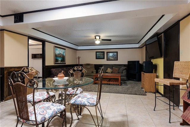 dining area featuring a textured ceiling, ceiling fan, and light tile patterned floors