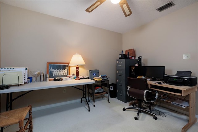 carpeted office with ceiling fan