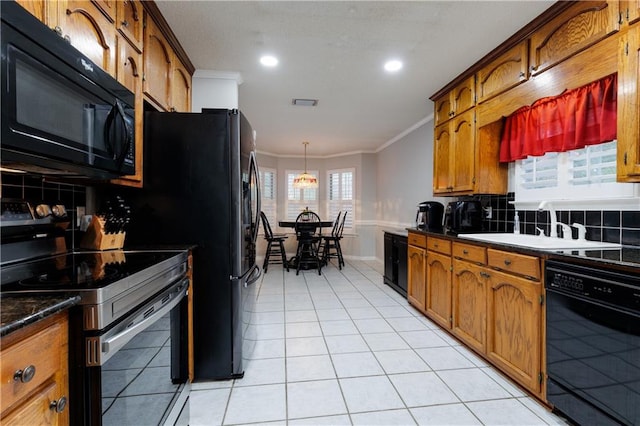 kitchen with crown molding, backsplash, light tile patterned floors, black appliances, and hanging light fixtures