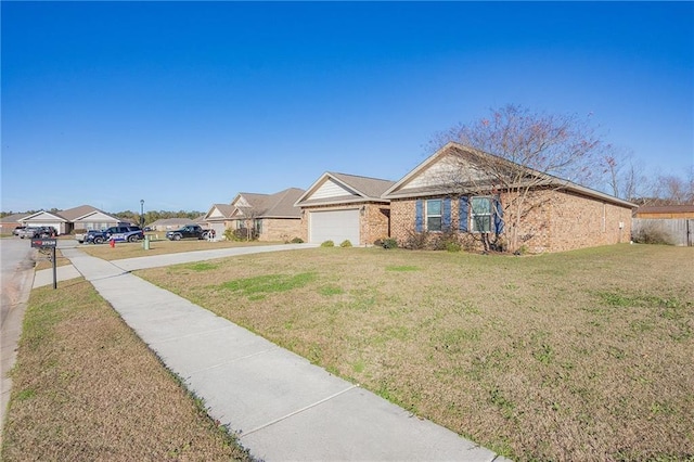 single story home featuring a garage and a front lawn