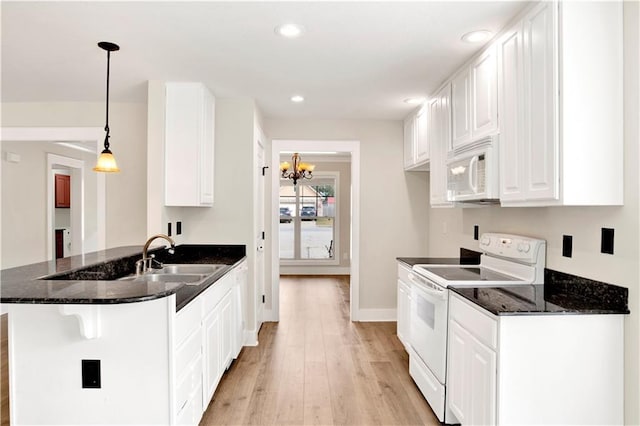 kitchen with light wood-type flooring, white appliances, pendant lighting, a notable chandelier, and white cabinetry