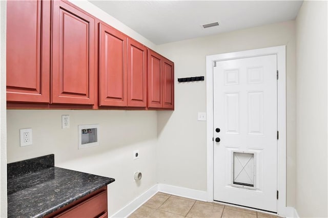 washroom with washer hookup, light tile patterned floors, cabinets, and hookup for an electric dryer