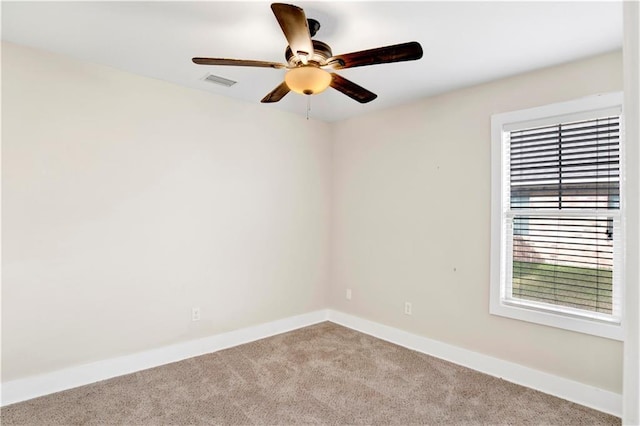 unfurnished room featuring light colored carpet and ceiling fan