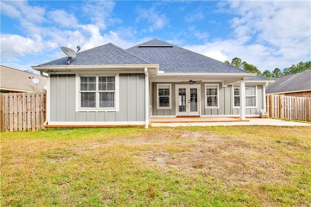 back of property featuring a lawn, ceiling fan, french doors, and a patio