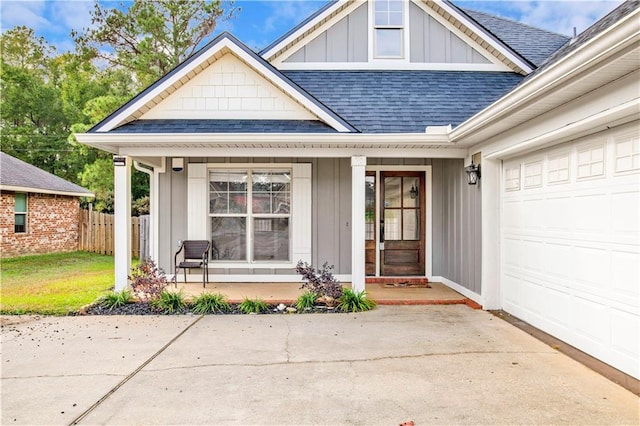 entrance to property with covered porch and a garage