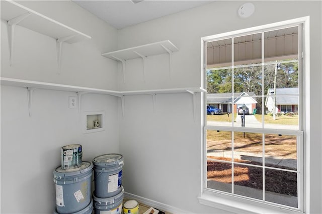 clothes washing area featuring washer hookup, laundry area, and baseboards