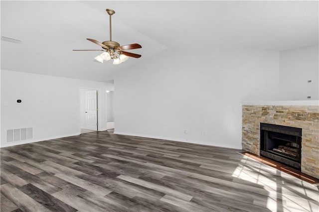 unfurnished living room featuring visible vents, ceiling fan, a stone fireplace, and wood finished floors