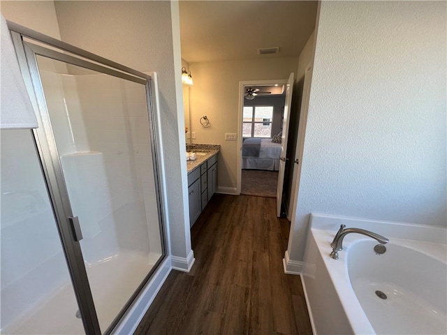 bathroom featuring vanity, hardwood / wood-style floors, and shower with separate bathtub