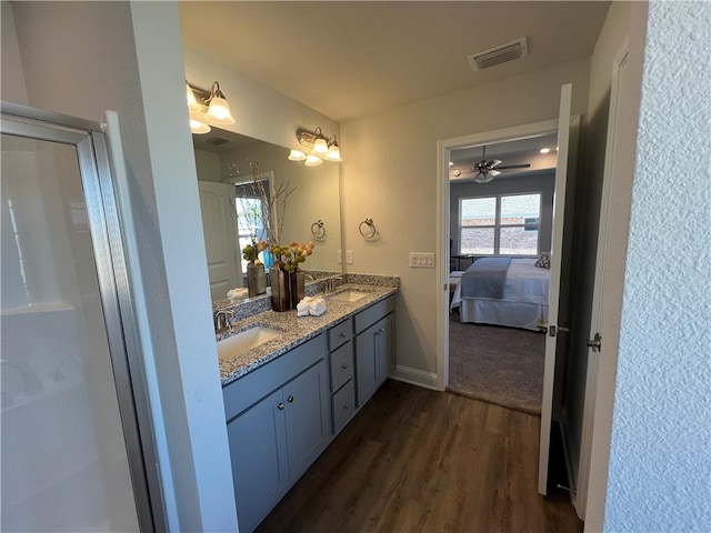 9299 Ofallon Dr N, Mobile, AL 36695 - full bathroom featuring wood finished floors, double vanity, ensuite bathroom, ceiling fan, and an enclosed shower