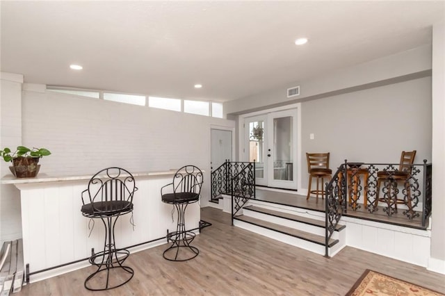 dining space with recessed lighting, visible vents, wood finished floors, and french doors