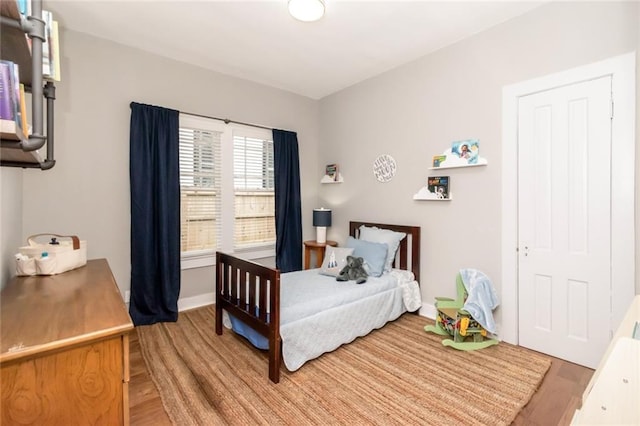 bedroom with light wood-style floors and baseboards