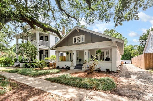 view of front of home featuring fence and covered porch