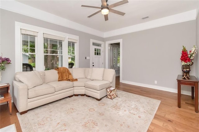 living room with ceiling fan, baseboards, a healthy amount of sunlight, and light wood-style flooring