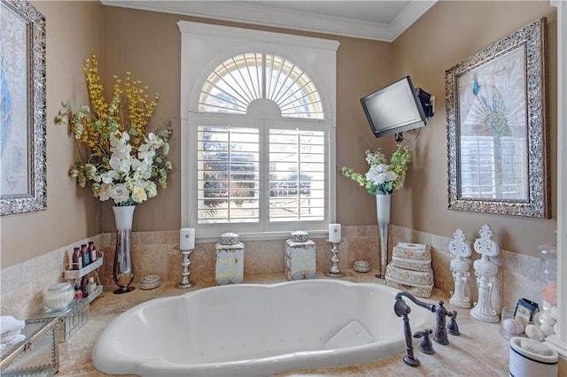 bathroom with crown molding and tiled tub